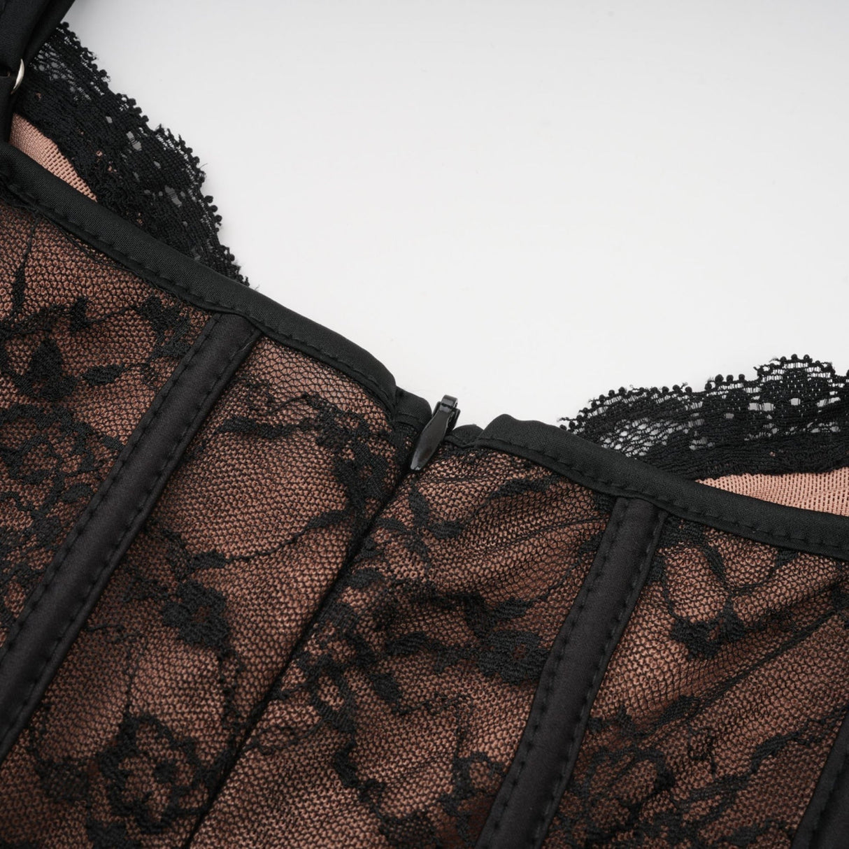 Woman wearing black floral lace sleeveless vest over matching midi dress with lace overlay