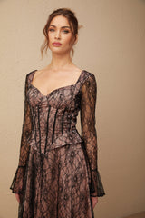 Woman wearing black lace midi dress with flared skirt and fitted bodice standing against plain background