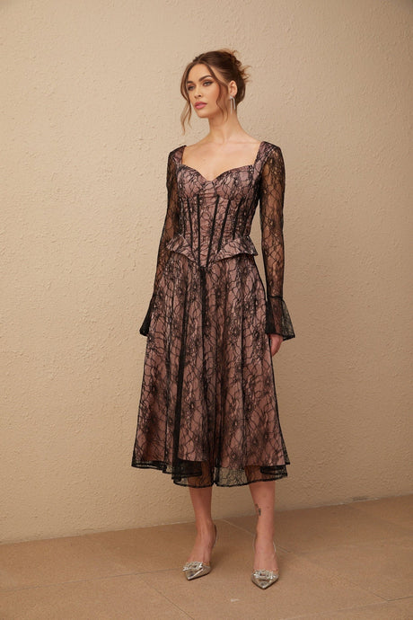 Woman wearing black lace midi dress with flared skirt and fitted bodice