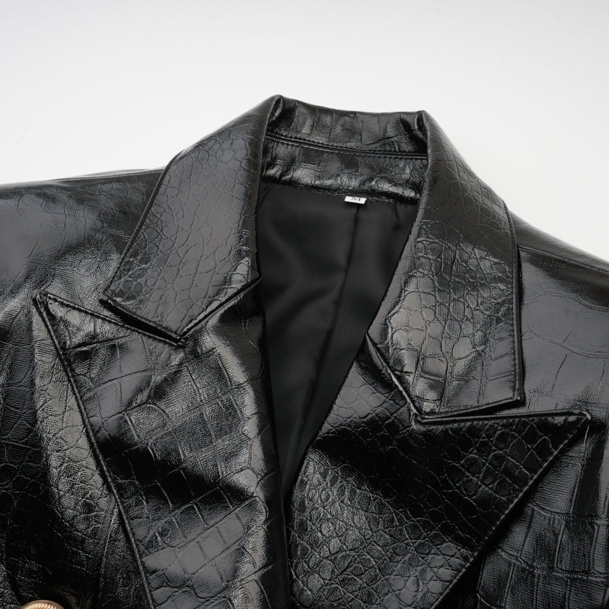 Woman wearing black leather jacket with cinched waist and zipper closure