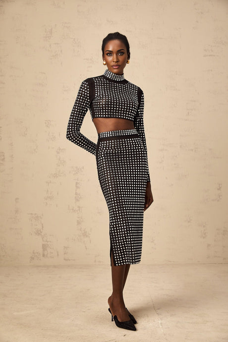 Woman wearing black mesh top and skirt set adorned with rhinestones elegant evening outfit