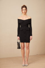 Woman wearing black offshoulder mini dress with ribbed knit texture and short skirt