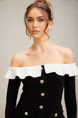 Woman wearing black offshoulder top with ruffle detail