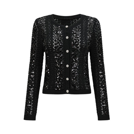 Woman wearing black sequined crochet knit cardigan and matching skirt set