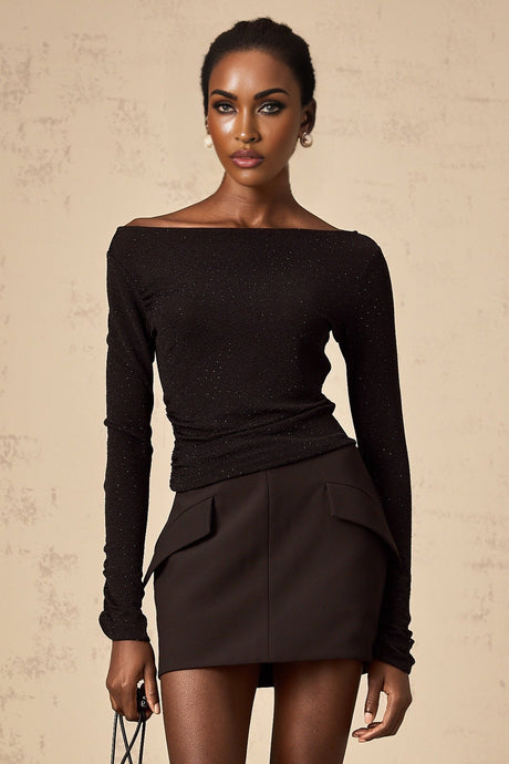 Woman wearing black sequined matching set with top and skirt Berenice design