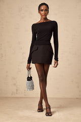Woman wearing black sequined matching top and skirt set