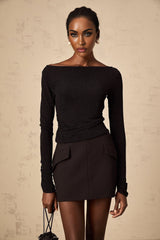 Woman wearing black sequined top and matching skirt set shimmering outfit for special occasions