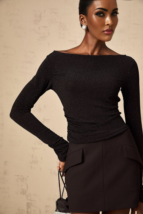 Woman wearing black sequined top and matching skirt set