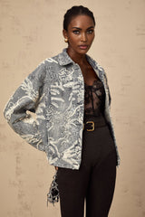 Woman wearing blue denim jacket with sequined flower embroidery