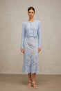Woman wearing blue floral lace matching top and skirt set with delicate pattern and feminine design
