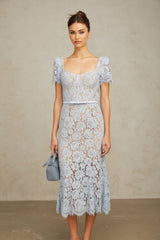Woman wearing blue floral lace midi dress with boned bodice and delicate straps