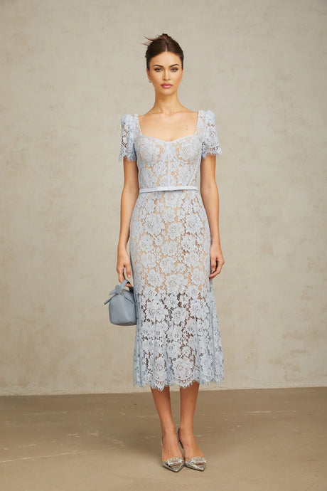 Woman wearing blue floral lace midi dress with boned bodice and fitted silhouette