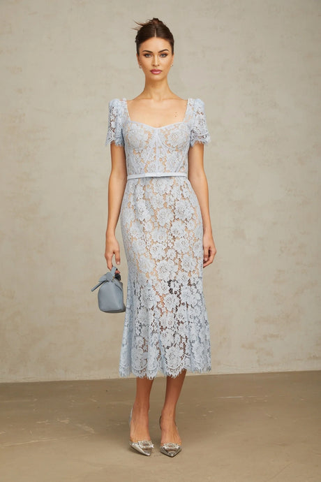 Woman wearing blue floral lace midi dress with boned bodice and fitted silhouette