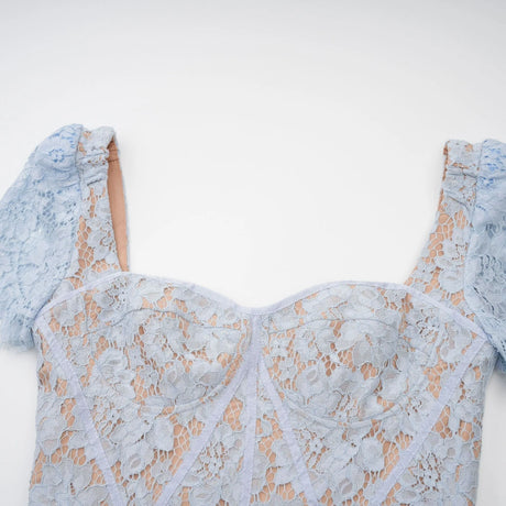 Woman wearing blue floral lace midi dress with boned bodice and fitted silhouette
