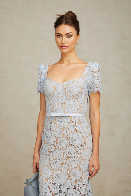 Woman wearing blue floral lace midi dress with boned bodice and fitted silhouette
