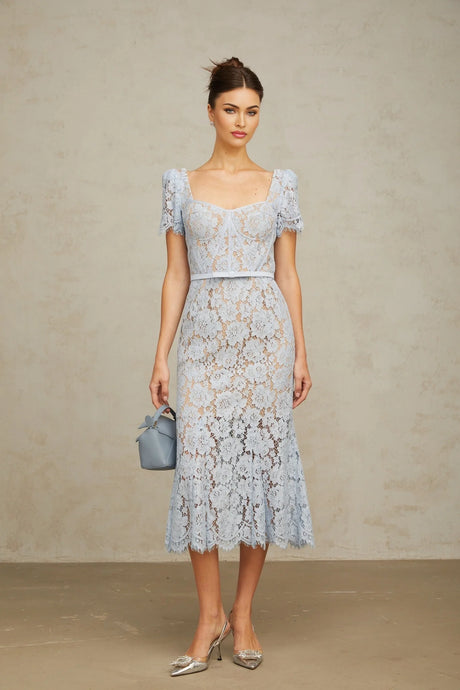 Woman wearing blue floral lace midi dress with boned bodice and fitted silhouette