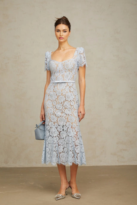 Woman wearing blue floral lace midi dress with boned bodice and thin straps
