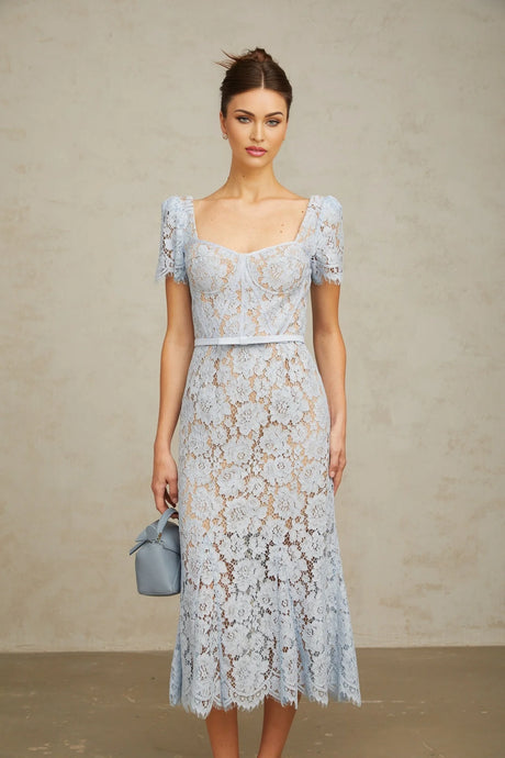 Woman wearing blue floral lace midi dress with boned bodice and thin straps