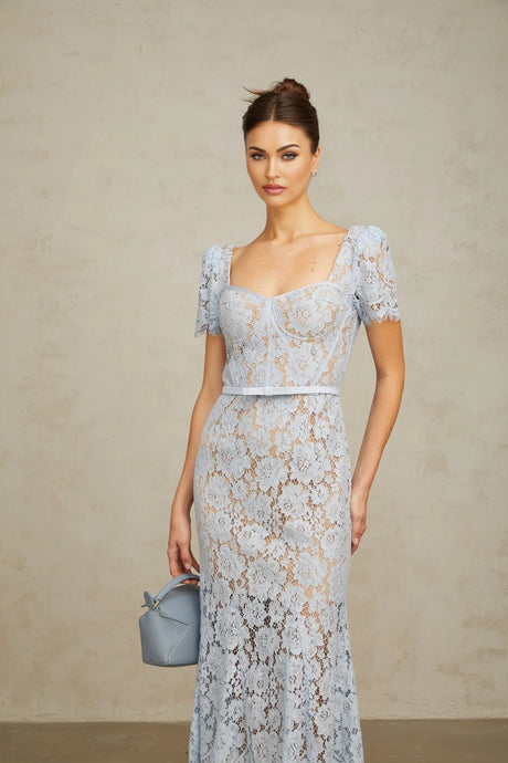 Woman wearing blue floral lace midi dress with boned bodice fitted waist and delicate straps