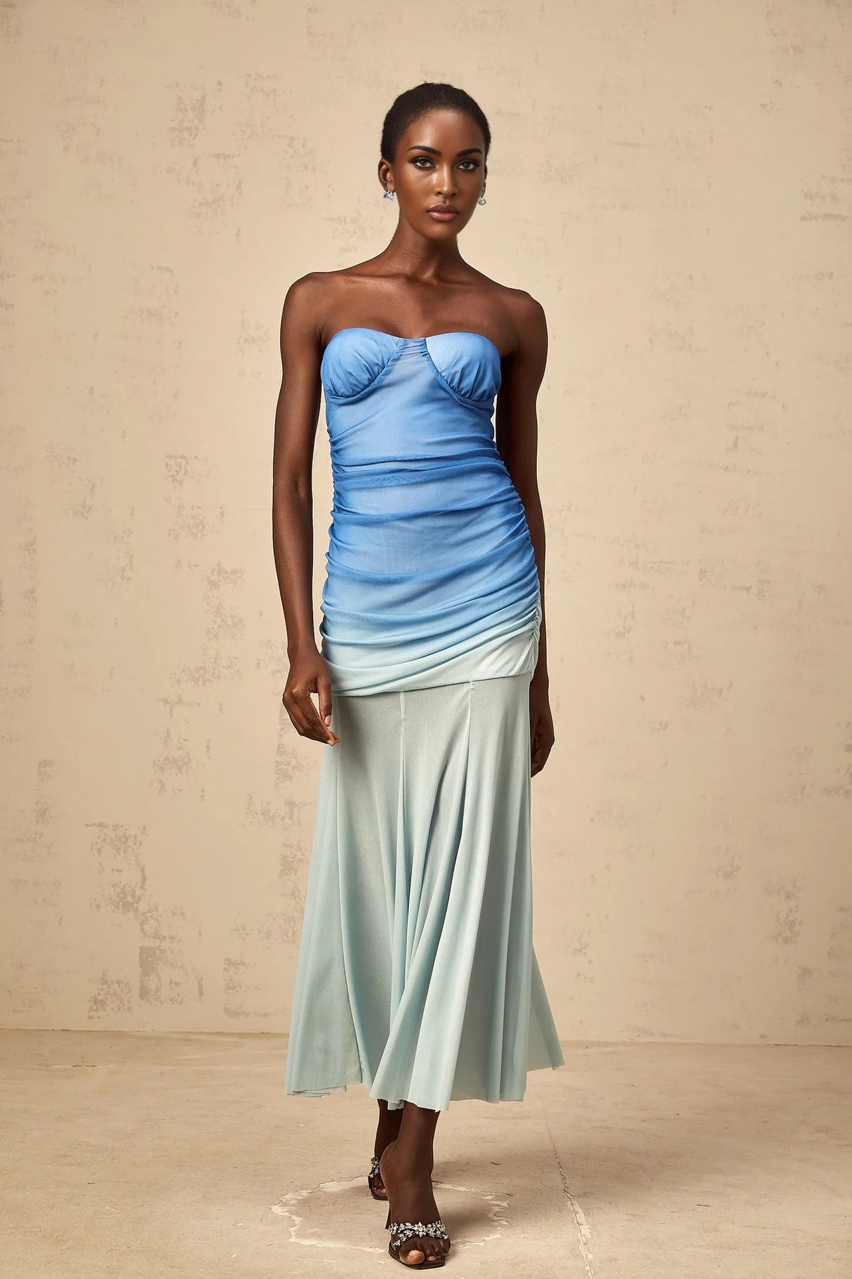 Woman wearing blue gradient mesh midi dress with long sleeves and flowing skirt