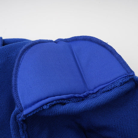 Woman wearing blue knitted top and skirt set with button details on both pieces