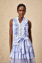 Woman wearing blue midi dress with ruffled tiers and floral lace trim