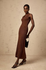 Woman wearing brown knitted midi dress with cut out details sleeveless design and form fitting silhouette