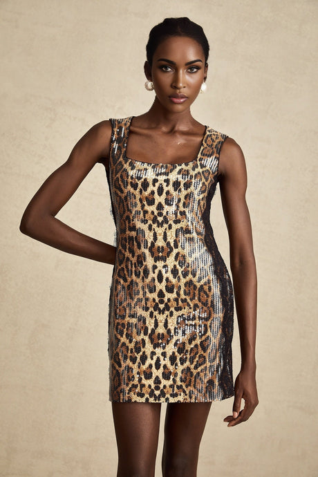 Woman wearing brown leopard print mini dress with lace details and sequin embellishments short sleeves form fitting silhouette