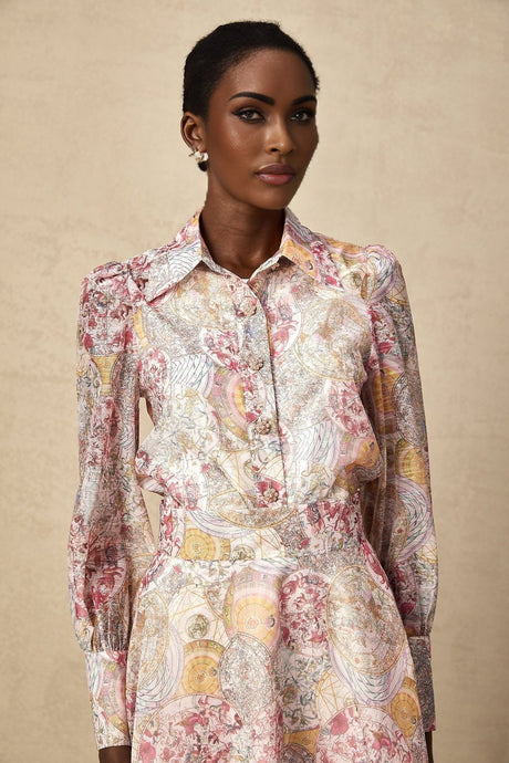 Woman wearing cherry pink shirt and skirt set with allover pattern print coordinated outfit