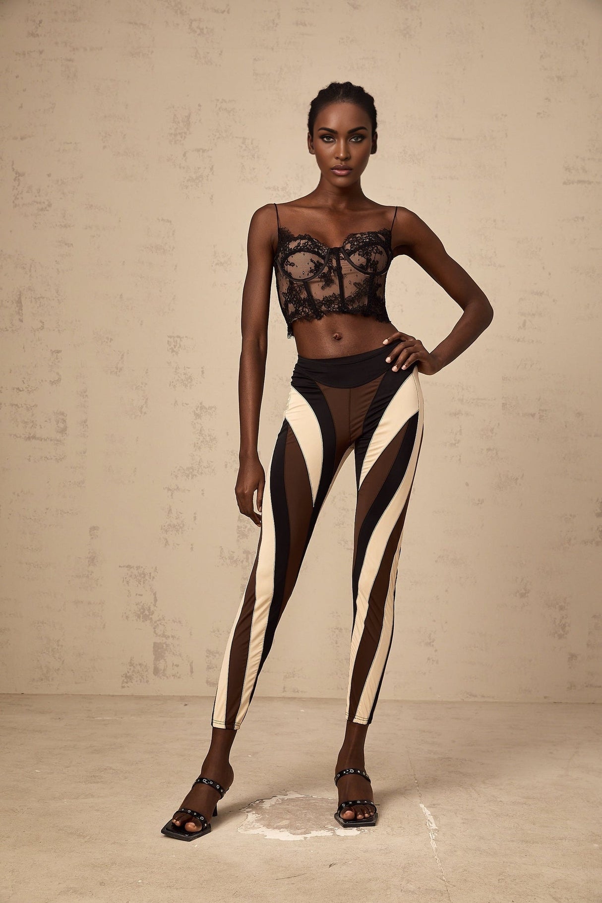 Woman wearing colorful spiral patterned leggings with color block panels in various bright hues