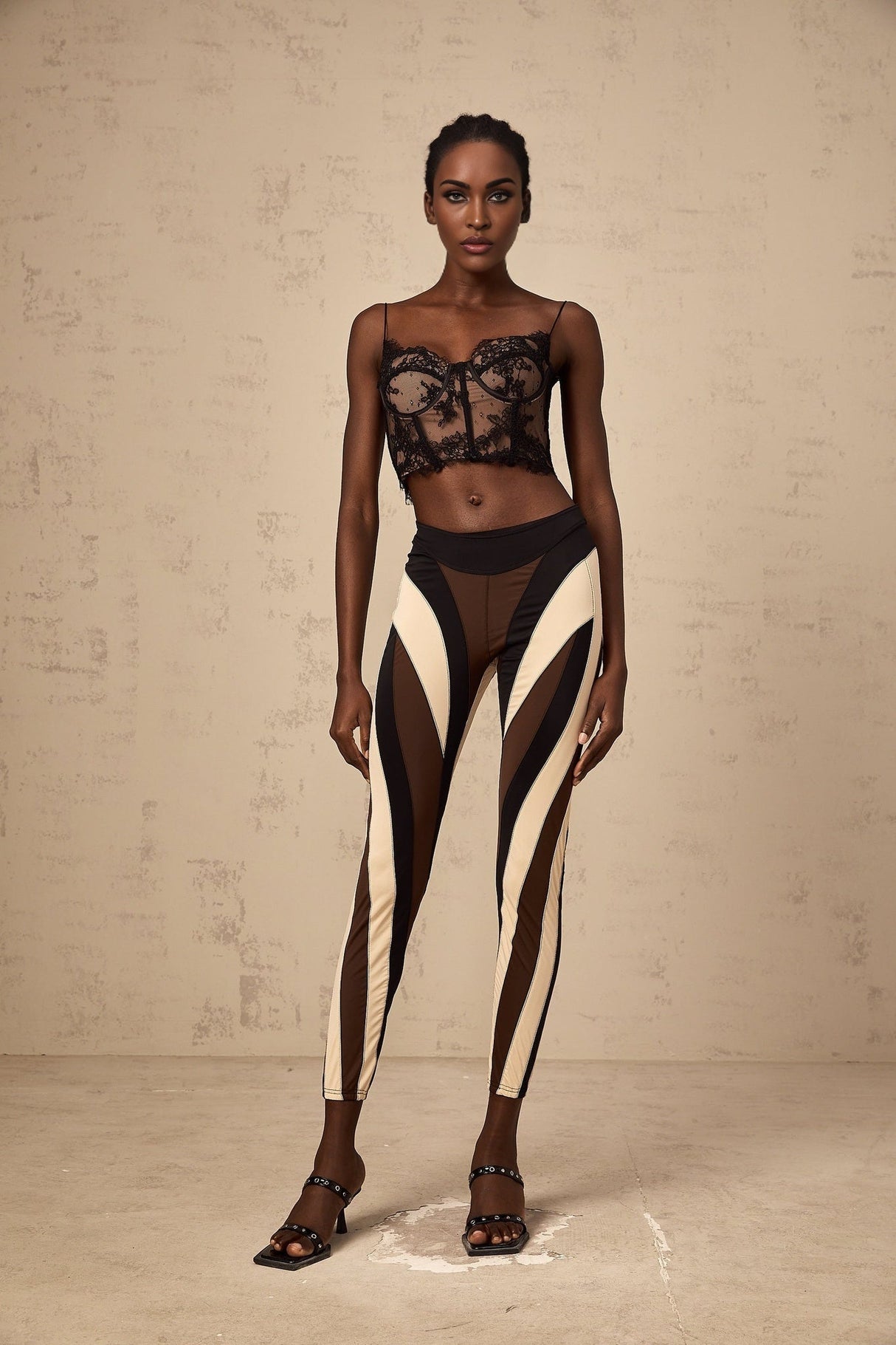 Woman wearing colorful spiral patterned leggings with color block panels in various shades
