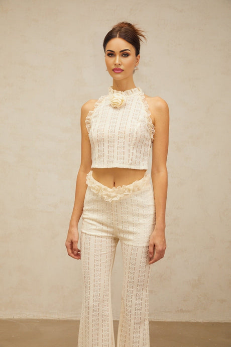 Woman wearing creamwhite matching set with ruffled lace trim top and trousers in jacquard fabric Magali design