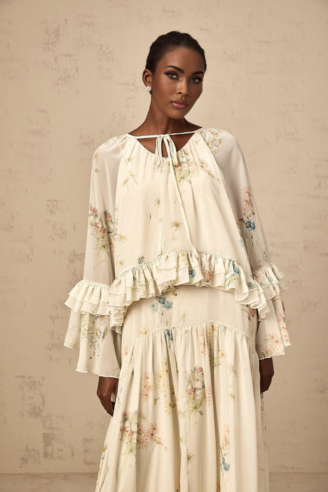 Woman wearing floral print matching blouse and dress set with ruffled details in Melissa style