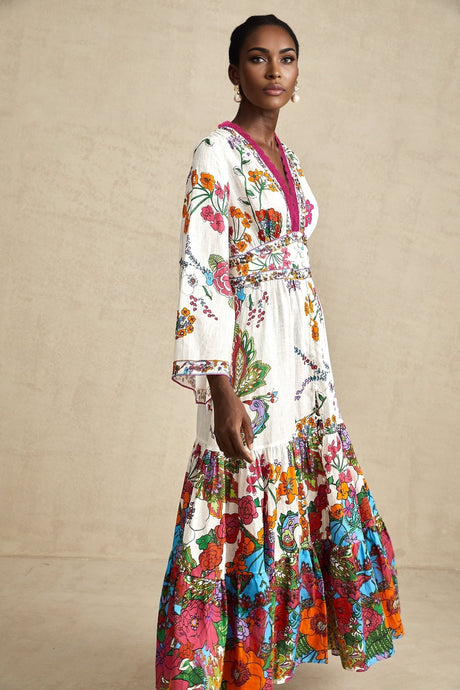 Woman wearing floral print midi dress with Vneck and flowing skirt in soft pastel colors