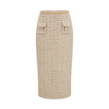Woman wearing gold tweed jacket and matching skirt with sequin embellishments elegant coordinated outfit set
