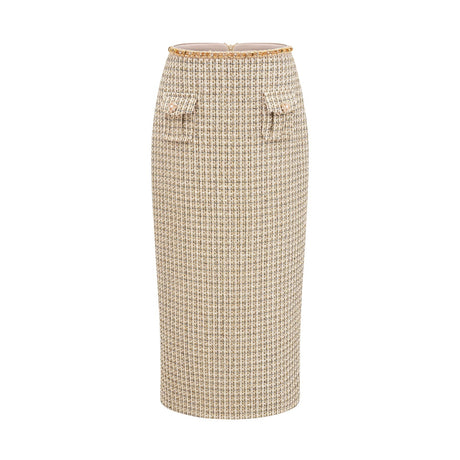 Woman wearing gold tweed jacket and matching skirt with sequin embellishments elegant coordinated outfit set