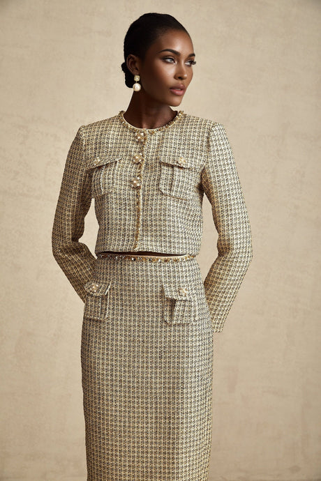 Woman wearing gold tweed jacket and matching skirt with sequin embellishments elegant formal outfit set