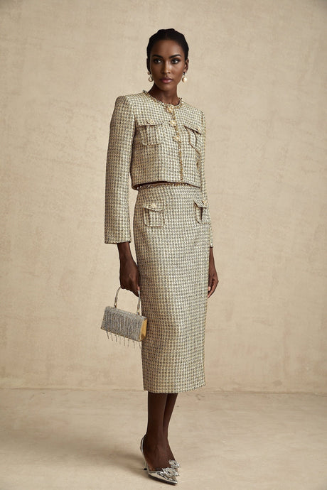 Woman wearing gold tweed jacket and matching skirt with sequin embellishments elegant two piece set for formal occasions
