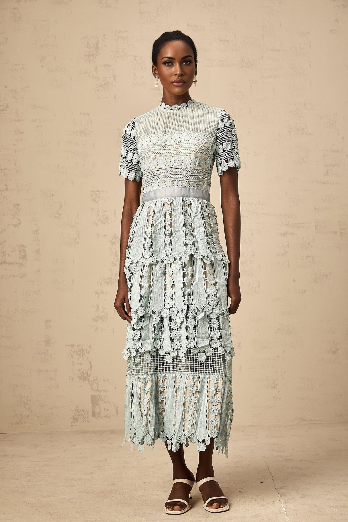 Woman wearing green midi dress with floral embroidery pattern
