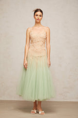 Woman wearing green midi dress with lace panels and tulle skirt
