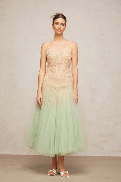 Woman wearing green midi dress with lace panels and tulle skirt