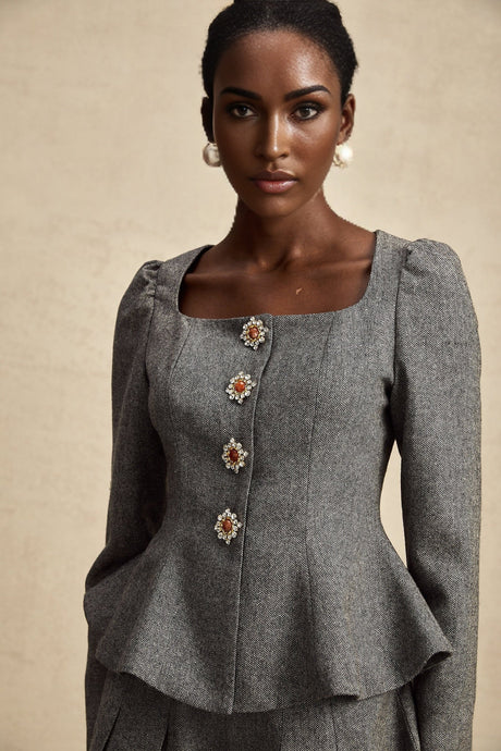 Woman wearing grey herringbone pattern matching top and shorts set named Agathe