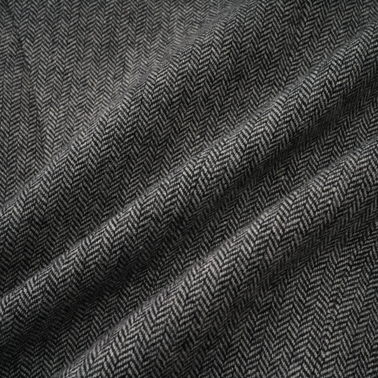 Woman wearing grey herringbone pattern matching top and shorts set