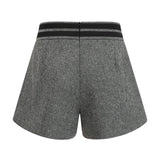 Woman wearing grey herringbone pattern matching top and shorts set