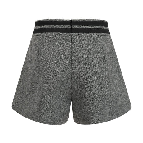 Woman wearing grey herringbone pattern matching top and shorts set