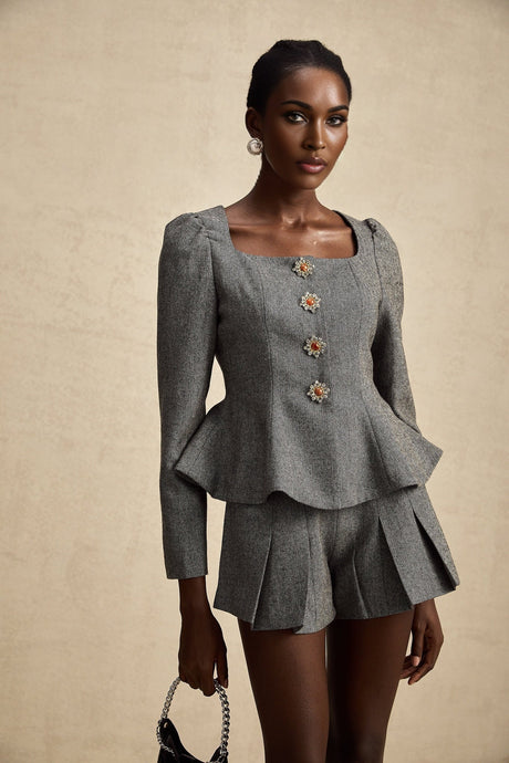 Woman wearing grey herringbone patterned top and matching shorts set Agathe design casual loungewear outfit