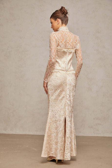 Woman wearing ivory matching set with top and skirt in patterned jacquard fabric