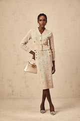 Woman wearing khaki colored matching cardigan and skirt set with star pattern crochet knit design