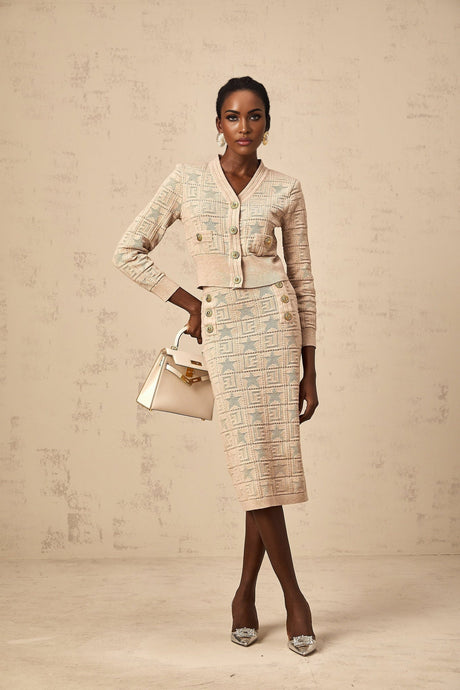 Woman wearing khaki colored matching cardigan and skirt set with star pattern crochet knit design