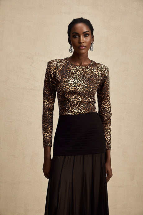 Woman wearing leopard print bodysuit with long sleeves and high neck